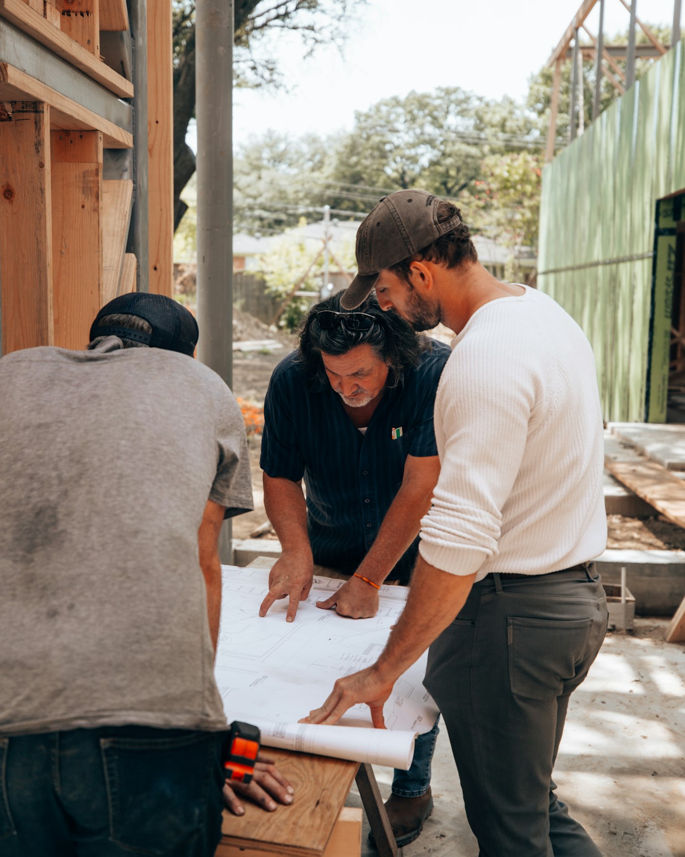 Team reviewing building plans on site